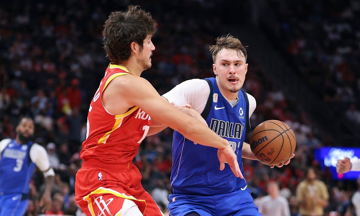 Dallas Mavericks forward Cooper Flagg drives with the ball in his right hand as Houston Rockets guard Reed Sheppard reaches in.