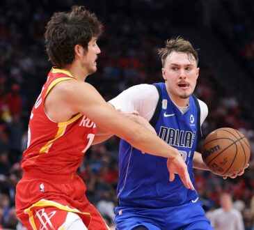 Dallas Mavericks forward Cooper Flagg drives with the ball in his right hand as Houston Rockets guard Reed Sheppard reaches in.