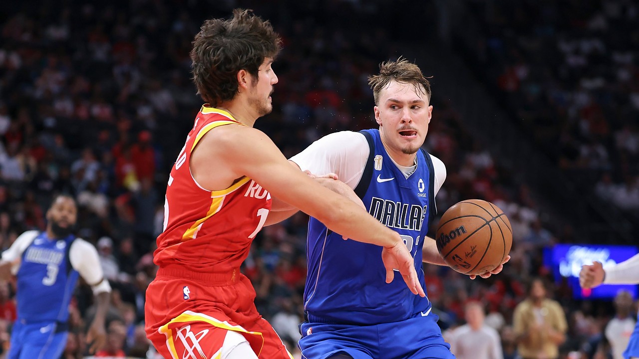 Dallas Mavericks forward Cooper Flagg drives with the ball in his right hand as Houston Rockets guard Reed Sheppard reaches in.