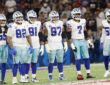 Dallas Cowboys defensive players stand in a row on the field during a game against the Baltimore Ravens in Rio de Janeiro.