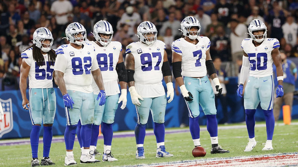 Dallas Cowboys defensive players stand in a row on the field during a game against the Baltimore Ravens in Rio de Janeiro.