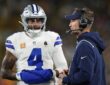 Cowboys quarterback Dak Prescott talks with head coach Brian Schottenheimer on the sideline.