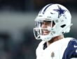 Dallas Cowboys quarterback Dak Prescott looks to his left and barks out a call at the line of scrimmage.