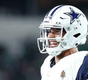 Dallas Cowboys quarterback Dak Prescott looks to his left and barks out a call at the line of scrimmage.