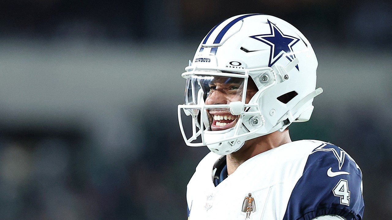 Dallas Cowboys quarterback Dak Prescott looks to his left and barks out a call at the line of scrimmage.