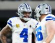 Cowboys quarterback Dak Prescott smiles while talking with center Cooper Beebe during pregame warmups