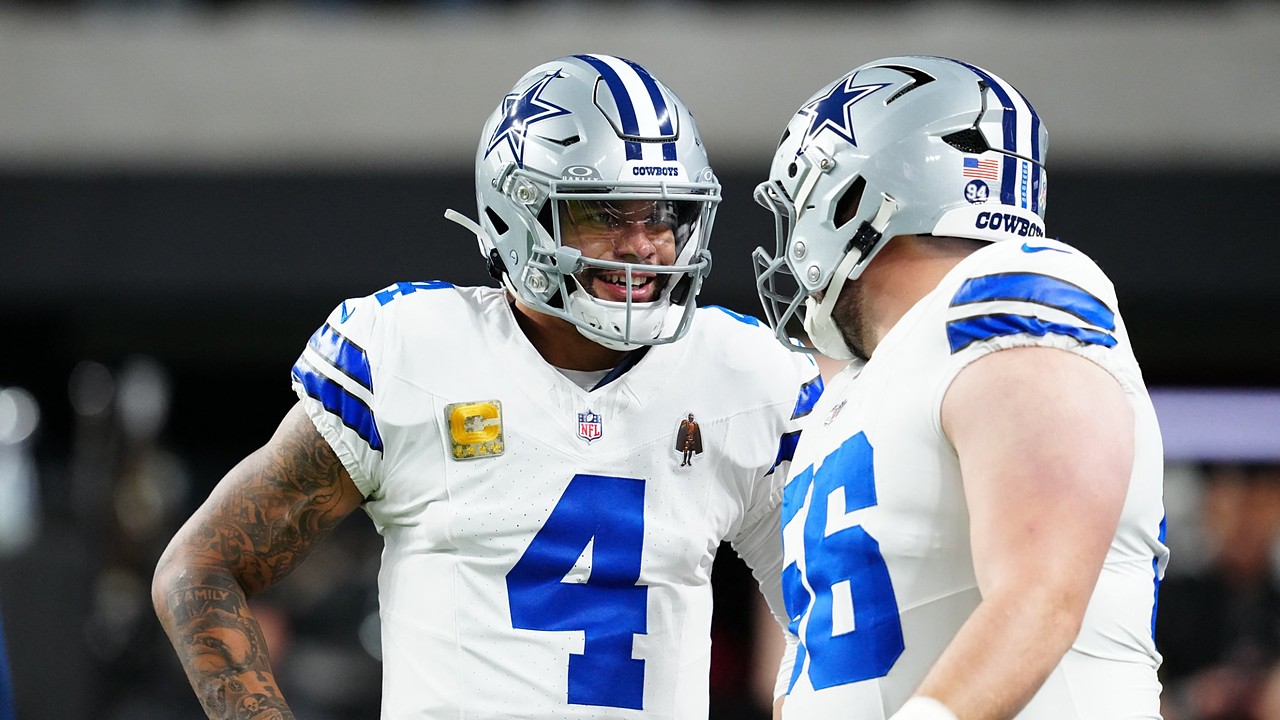 Cowboys quarterback Dak Prescott smiles while talking with center Cooper Beebe during pregame warmups