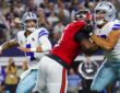 Cowboys quarterback Dak Prescott winds up to throw as a Cowboys lineman blocks a Buccaneers pass rusher.