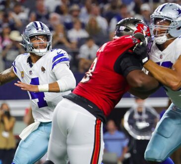 Cowboys quarterback Dak Prescott winds up to throw as a Cowboys lineman blocks a Buccaneers pass rusher.