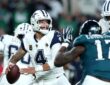 Dallas Cowboys quarterback Dak Prescott cocks the ball to throw as a Philadelphia Eagles pass rusher closes in.