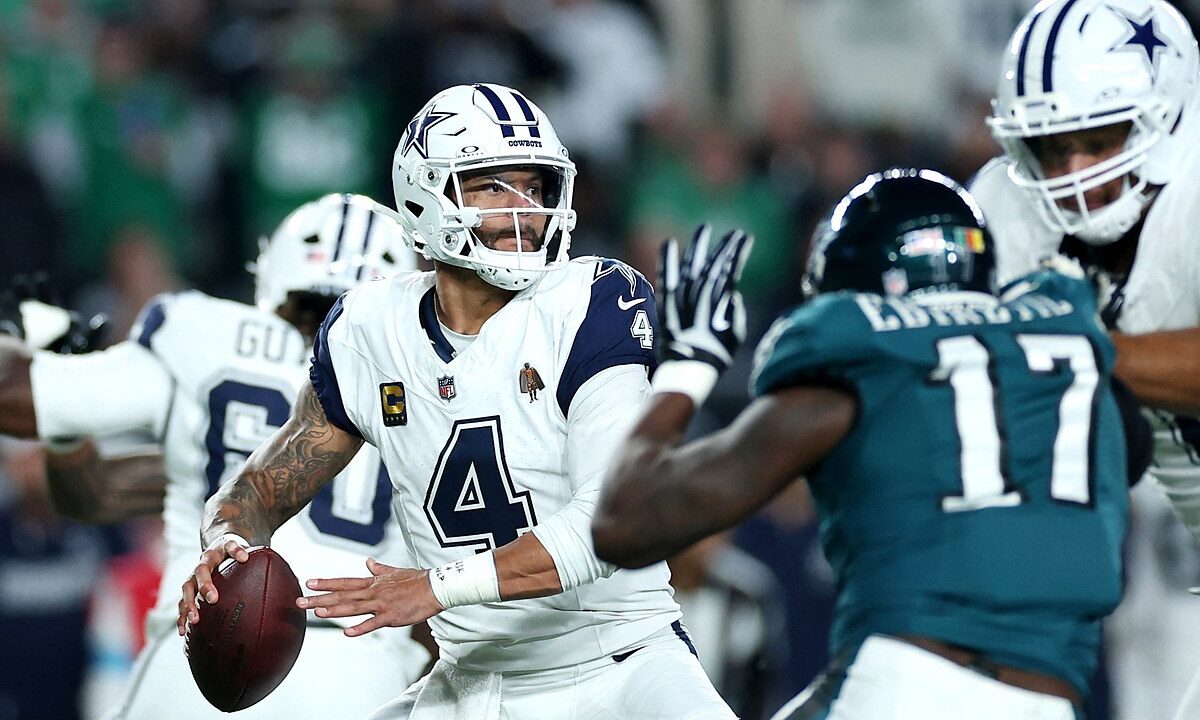 Dallas Cowboys quarterback Dak Prescott cocks the ball to throw as a Philadelphia Eagles pass rusher closes in.