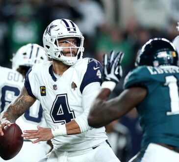 Dallas Cowboys quarterback Dak Prescott cocks the ball to throw as a Philadelphia Eagles pass rusher closes in.