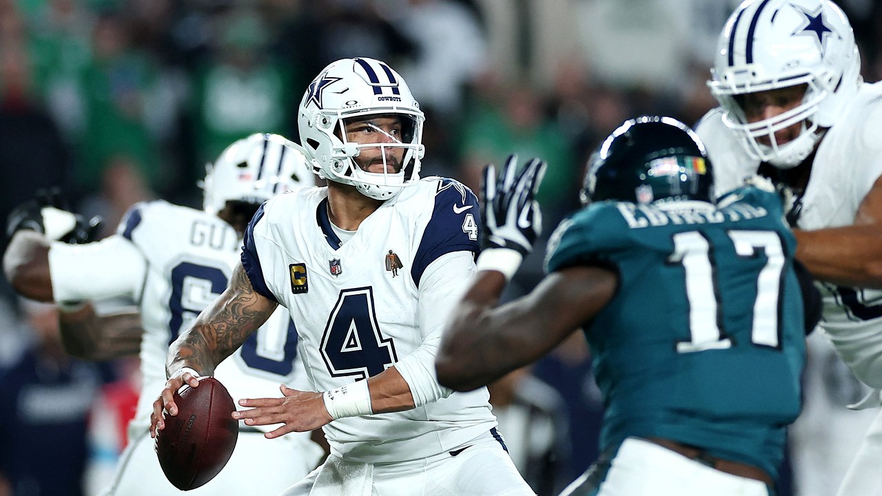 Dallas Cowboys quarterback Dak Prescott cocks the ball to throw as a Philadelphia Eagles pass rusher closes in.