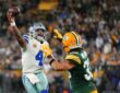 Dallas Cowboys quarterback Dak Prescott throws a pass on the run as Green Bay Packers safety Evan Williams closes in.