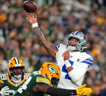 Dallas Cowboys quarterback Dak Prescott releases a pass as Green Bay Packers linebacker Zaire Franklin hits him.