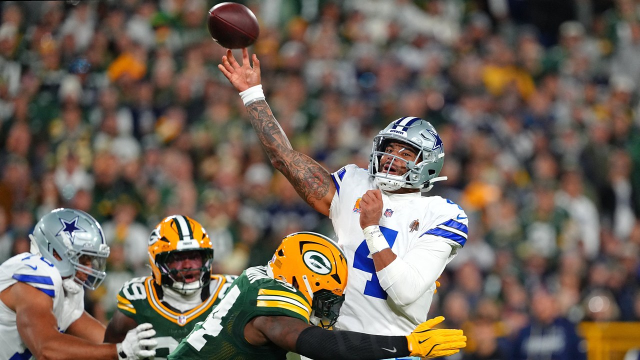 Dallas Cowboys quarterback Dak Prescott releases a pass as Green Bay Packers linebacker Zaire Franklin hits him.