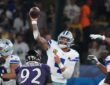Dallas Cowboys quarterback Dak Prescott throws a pass from the pocket as a Baltimore Ravens defender rushes.