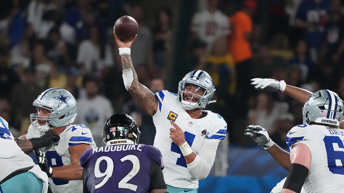 Dallas Cowboys quarterback Dak Prescott throws a pass from the pocket as a Baltimore Ravens defender rushes.