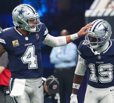Cowboys quarterback Dak Prescott pats wide receiver Ryan Flournoy on the helmet after a score.
