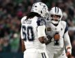 Dallas Cowboys quarterback Dak Prescott pumps his fist with offensive tackle Tyler Guyton, who wears No. 60, after a score.