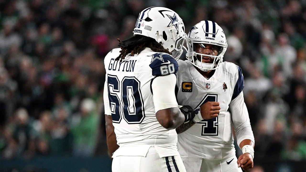 Dallas Cowboys quarterback Dak Prescott pumps his fist with offensive tackle Tyler Guyton, who wears No. 60, after a score.