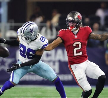 Cowboys cornerback DaRon Bland reaches for a loose pass in front of Buccaneers wide receiver Emeka Egbuka.