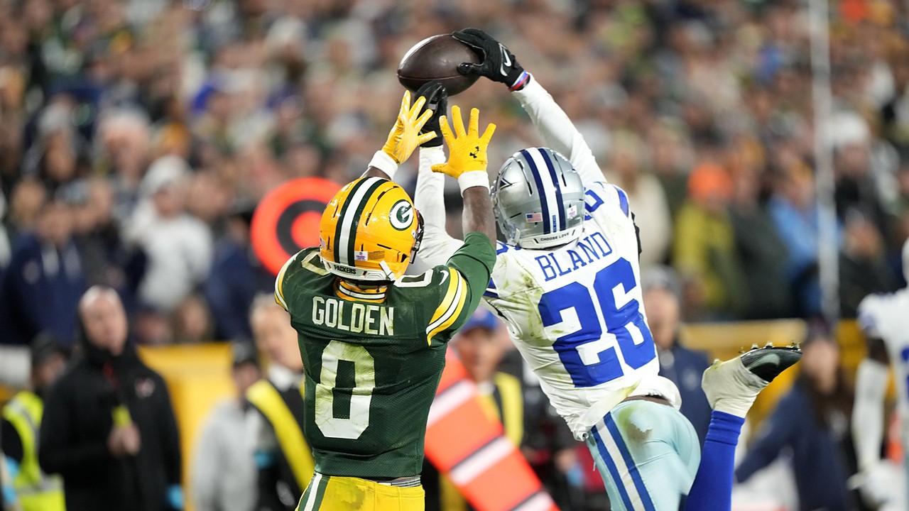 Dallas Cowboys cornerback DaRon Bland leaps to knock away a pass over Green Bay Packers wide receiver Matthew Golden.
