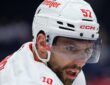 Then-Detroit Red Wings left wing David Perron, in a white helmet and visor, looks across the ice during warmups.