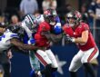 Cowboys linebacker Donovan Ezeiruaku and teammates wrap up Buccaneers running back Bucky Irving on a run.