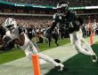 Dallas Cowboys wide receiver George Pickens dives to secure a touchdown catch at the pylon as an Eagles safety closes in.