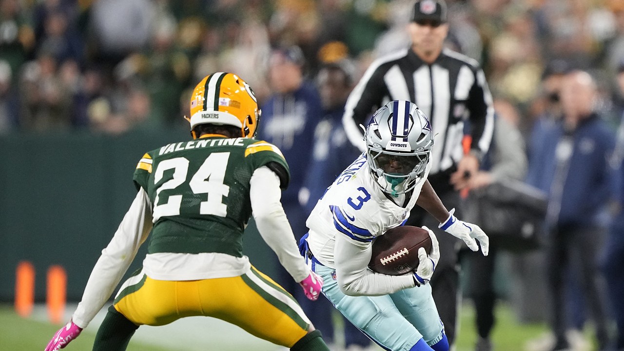 Dallas Cowboys wide receiver George Pickens cuts upfield with the ball as Green Bay Packers cornerback Carrington Valentine squares up.
