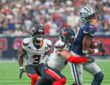 Cowboys wide receiver George Pickens clutches the ball as a Texans defender wraps him up from behind.