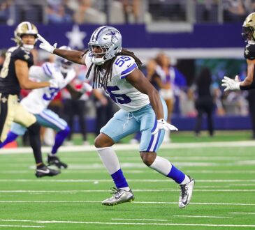 Cowboys linebacker Jaishawn Barham points as he backpedals into coverage with Saints players running routes nearby.