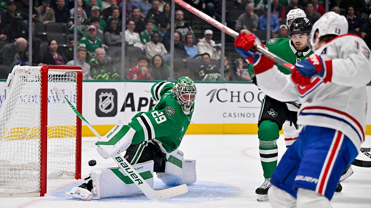 Dallas Stars goaltender Jake Oettinger drops into a split as the puck slides past his pad toward the net.