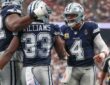 Cowboys quarterback Dak Prescott shouts as he greets running back Javonte Williams while a lineman pats Williams’ helmet.