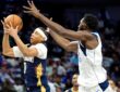 Pelicans guard Jeremiah Fears snatches the ball in midair as Mavericks center Moussa Cisse reaches in from behind.