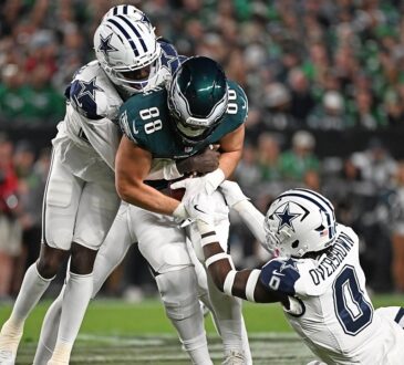 Dallas Cowboys cornerback Joey Porter Jr. and linebacker DeMarvion Overshown drag down Philadelphia Eagles tight end Dallas Goedert.