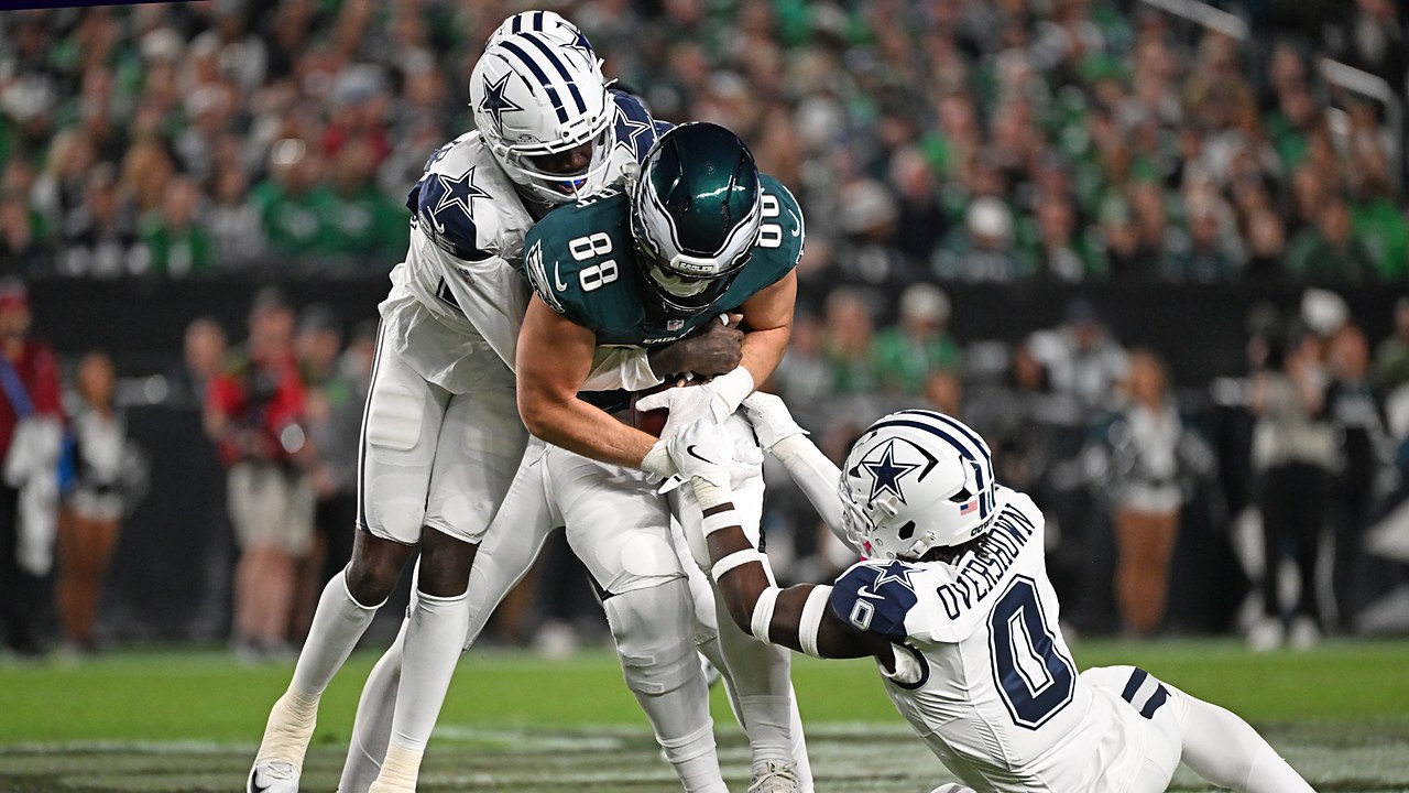 Dallas Cowboys cornerback Joey Porter Jr. and linebacker DeMarvion Overshown drag down Philadelphia Eagles tight end Dallas Goedert.