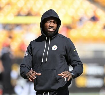 Then-Pittsburgh Steelers cornerback Joey Porter Jr. walks the field in a black hooded Steelers sweatshirt during pregame warmups.
