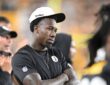Then-Pittsburgh Steelers cornerback Joey Porter Jr. watches from the sideline with his arms crossed in a Steelers cap.