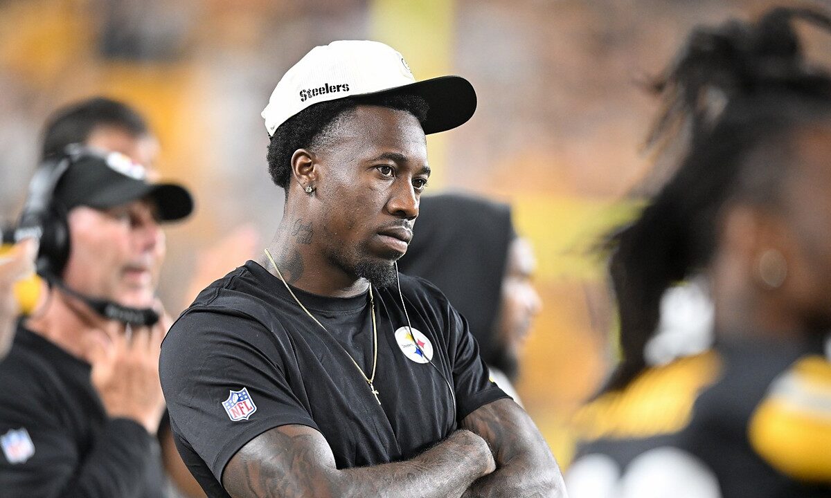 Then-Pittsburgh Steelers cornerback Joey Porter Jr. watches from the sideline with his arms crossed in a Steelers cap.