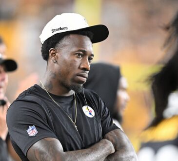 Then-Pittsburgh Steelers cornerback Joey Porter Jr. watches from the sideline with his arms crossed in a Steelers cap.