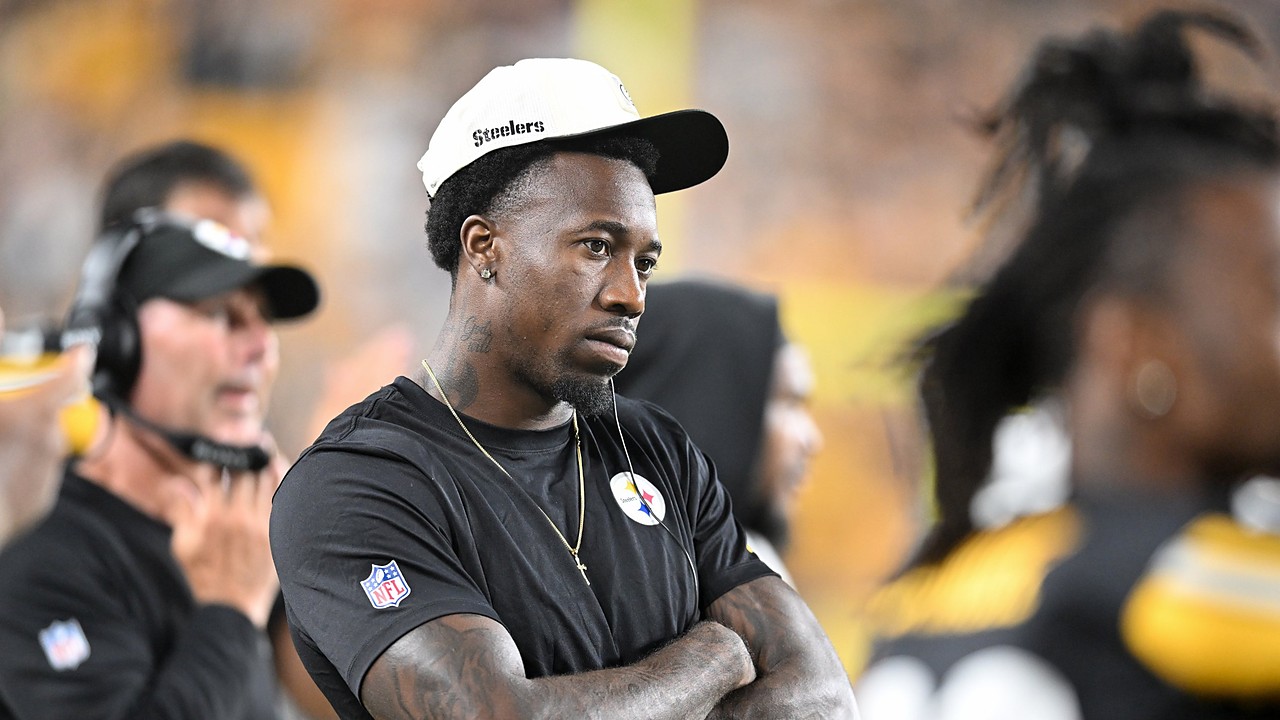 Then-Pittsburgh Steelers cornerback Joey Porter Jr. watches from the sideline with his arms crossed in a Steelers cap.