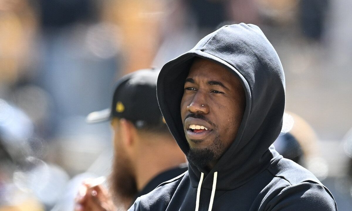 Pittsburgh Steelers cornerback Joey Porter Jr. stands with his arms crossed in a black team hoodie during pregame warm-ups.