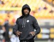 Pittsburgh Steelers cornerback Joey Porter Jr. stands on the field in a team hoodie during pregame warm-ups.