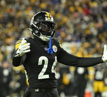 Pittsburgh Steelers cornerback Joey Porter Jr. spreads his arms wide while reacting on the field.