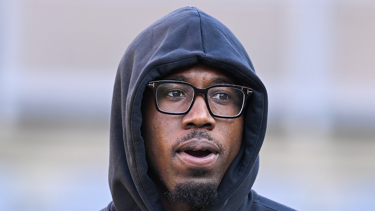 Pittsburgh Steelers cornerback Joey Porter Jr. stands in a hooded team sweatshirt and glasses.