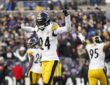 Pittsburgh Steelers cornerback Joey Porter Jr. celebrates in the end zone with one fist raised and the other arm pointing.