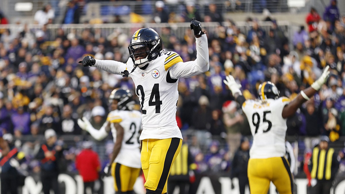 Pittsburgh Steelers cornerback Joey Porter Jr. celebrates in the end zone with one fist raised and the other arm pointing.