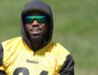 Pittsburgh Steelers cornerback Joey Porter Jr. smiles in sunglasses and a hood while watching practice.